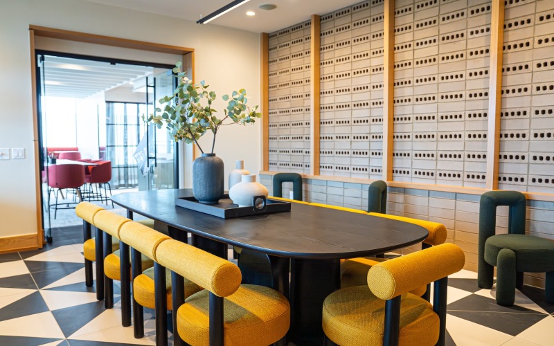 a table with yellow chairs and a plant on top
